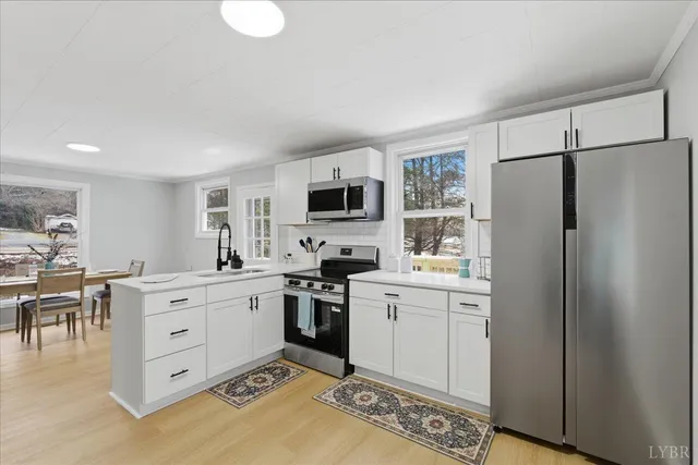 a kitchen with white cabinets and white appliances