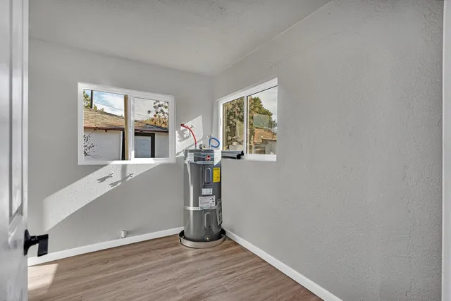 a kitchen with cabinets wooden floor and a sink