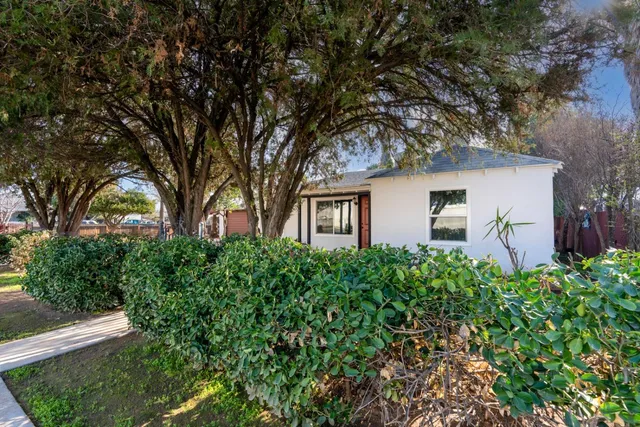 a front view of a house with yard and green space
