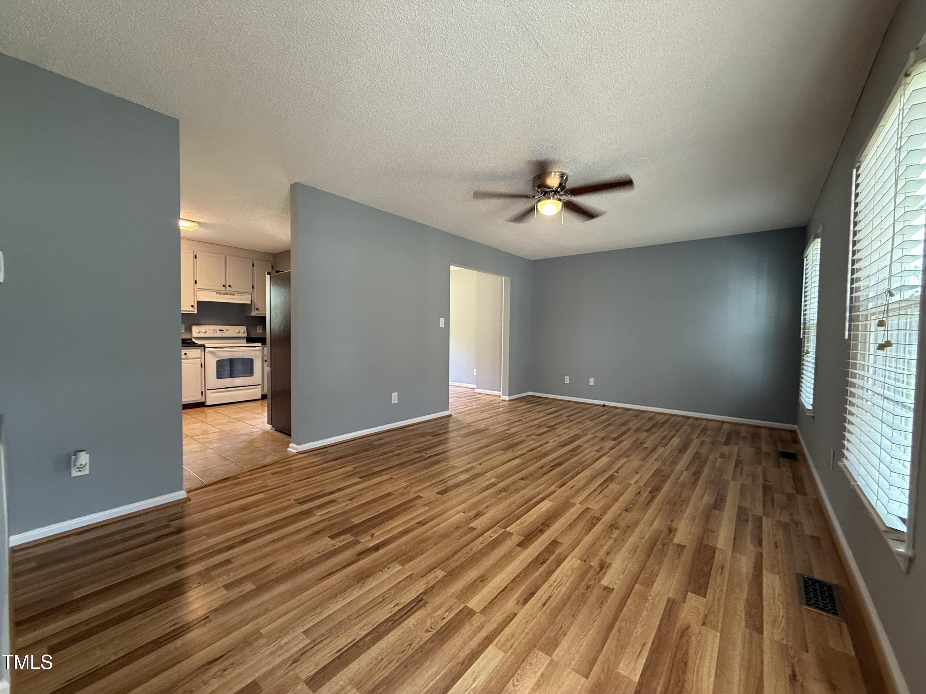 152 Christopher Avenue Princeton, NC 27569 - Photo 12 of 24 a view of empty room with wooden floor and fan
