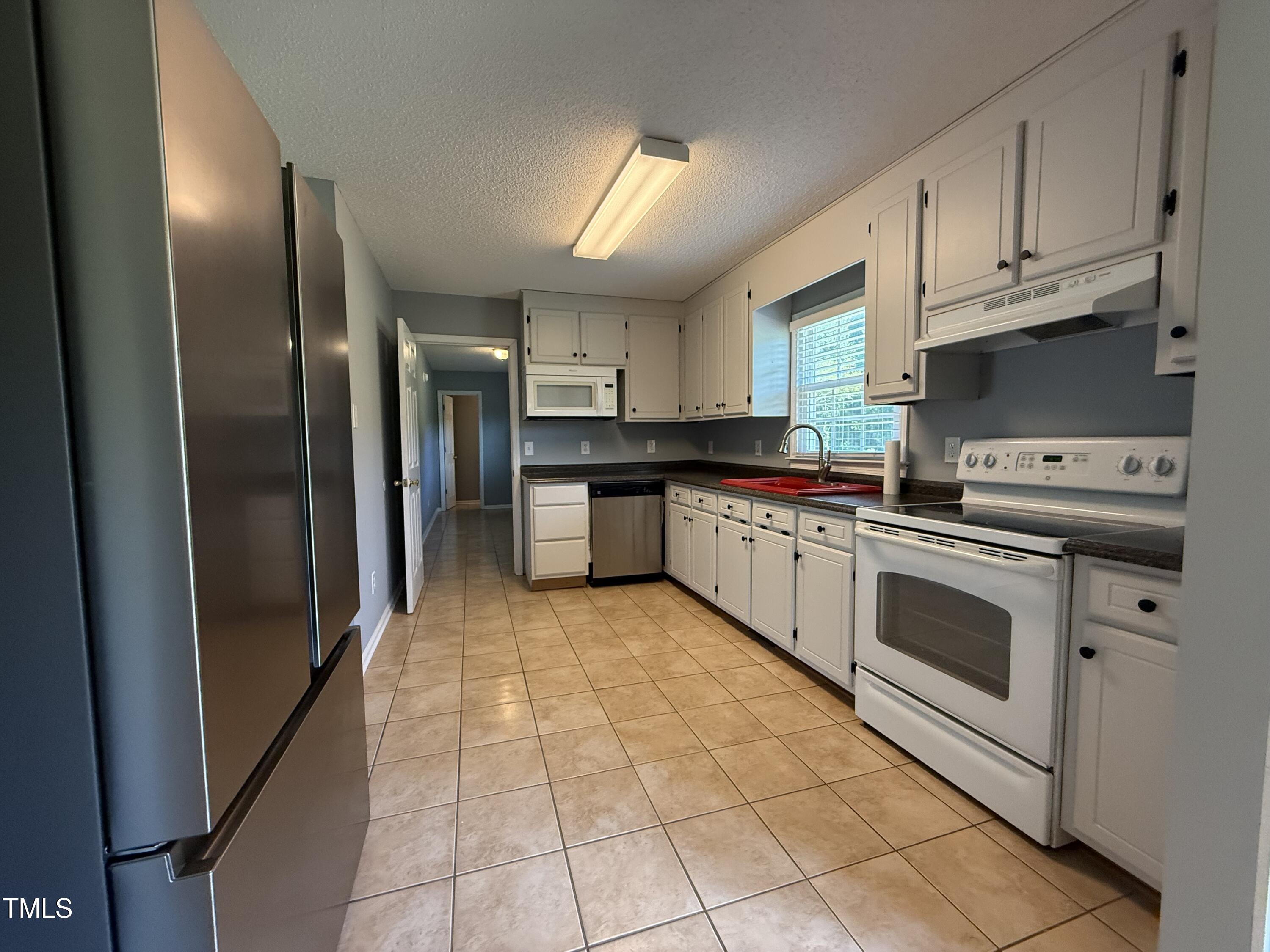 152 Christopher Avenue Princeton, NC 27569 - Photo 15 of 24 a kitchen with stainless steel appliances granite countertop a stove a sink and a refrigerator