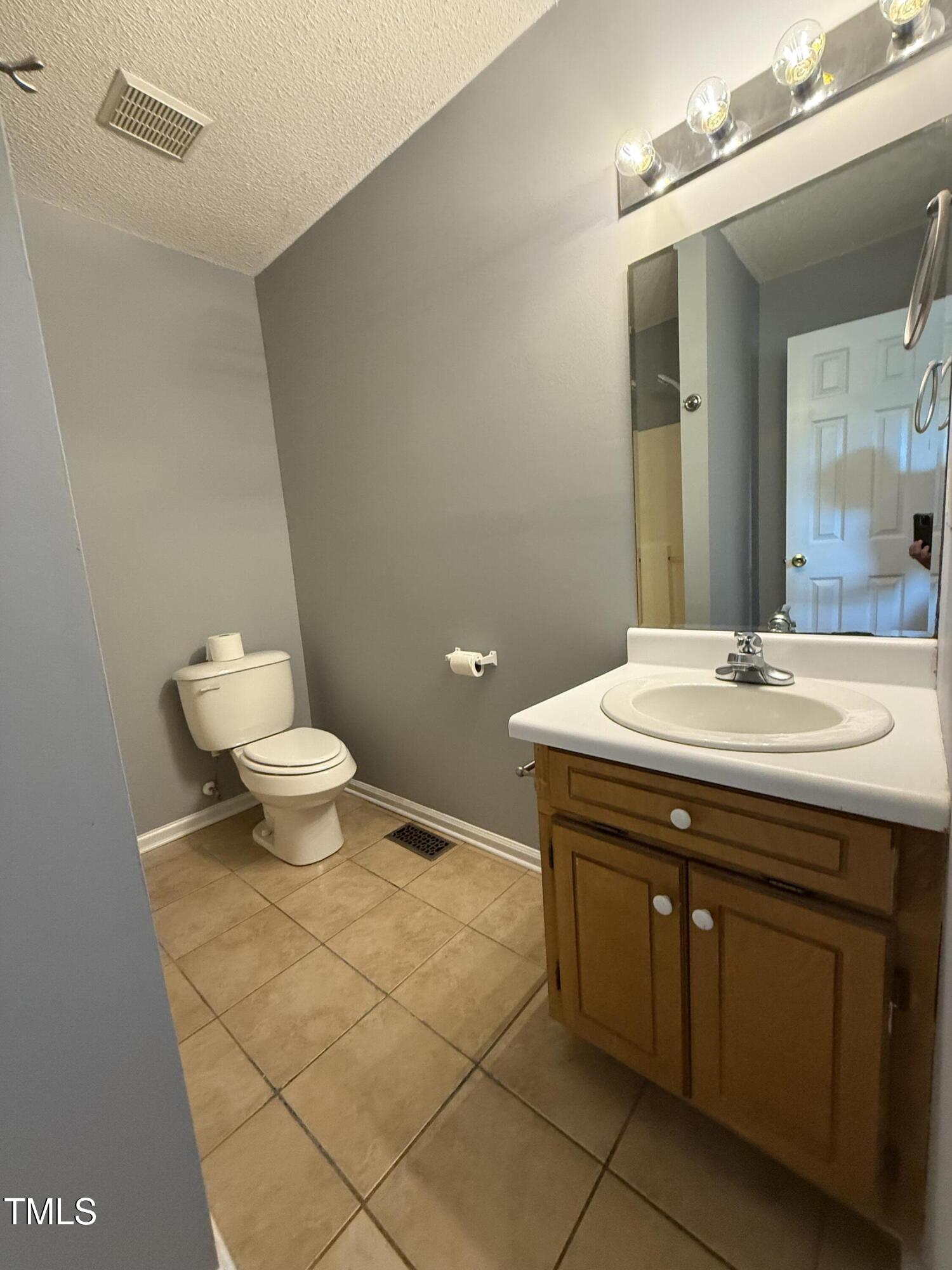 152 Christopher Avenue Princeton, NC 27569 - Photo 17 of 24 a bathroom with a sink a toilet and a mirror