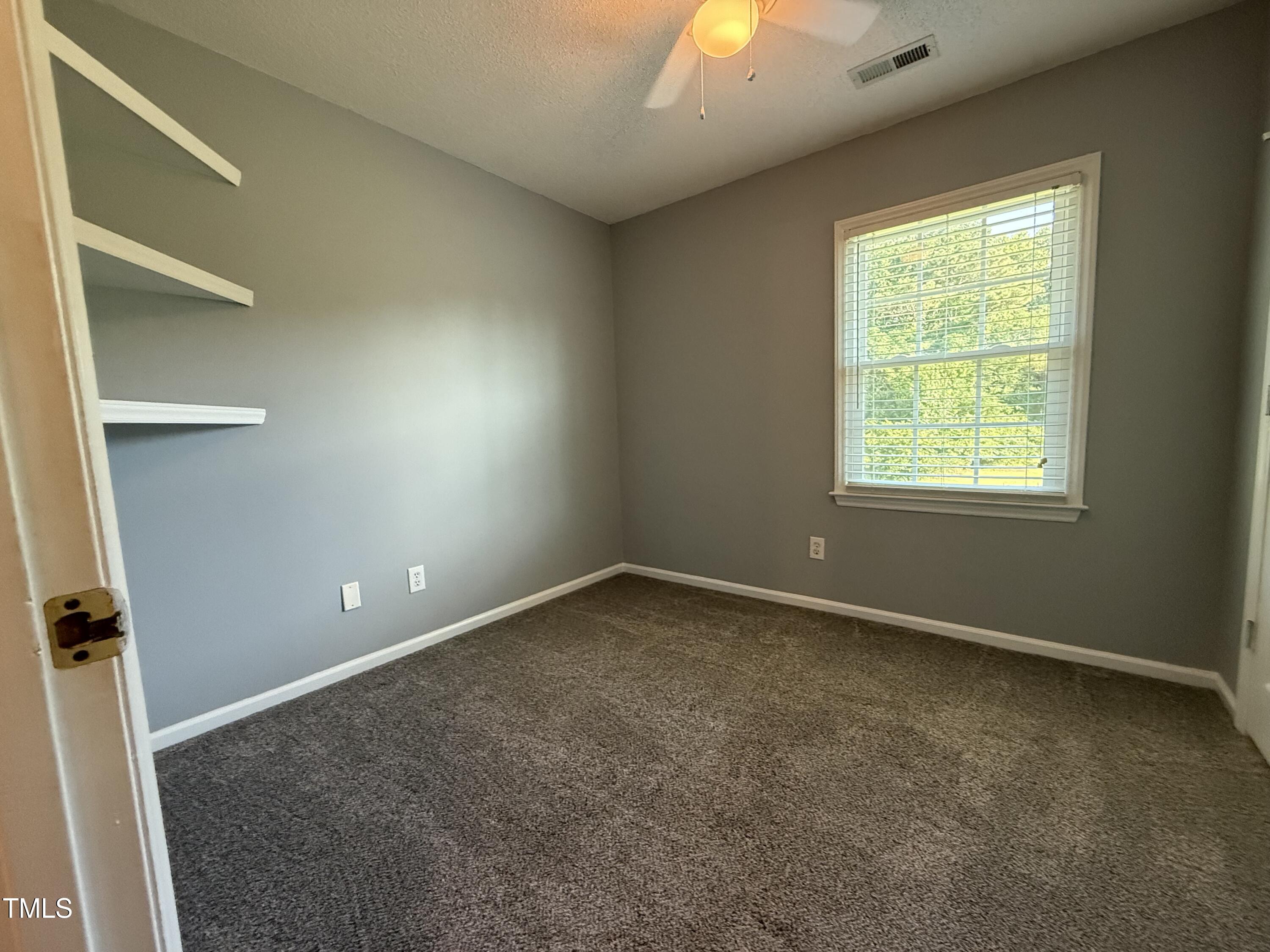 152 Christopher Avenue Princeton, NC 27569 - Photo 21 of 24 an empty room with a window