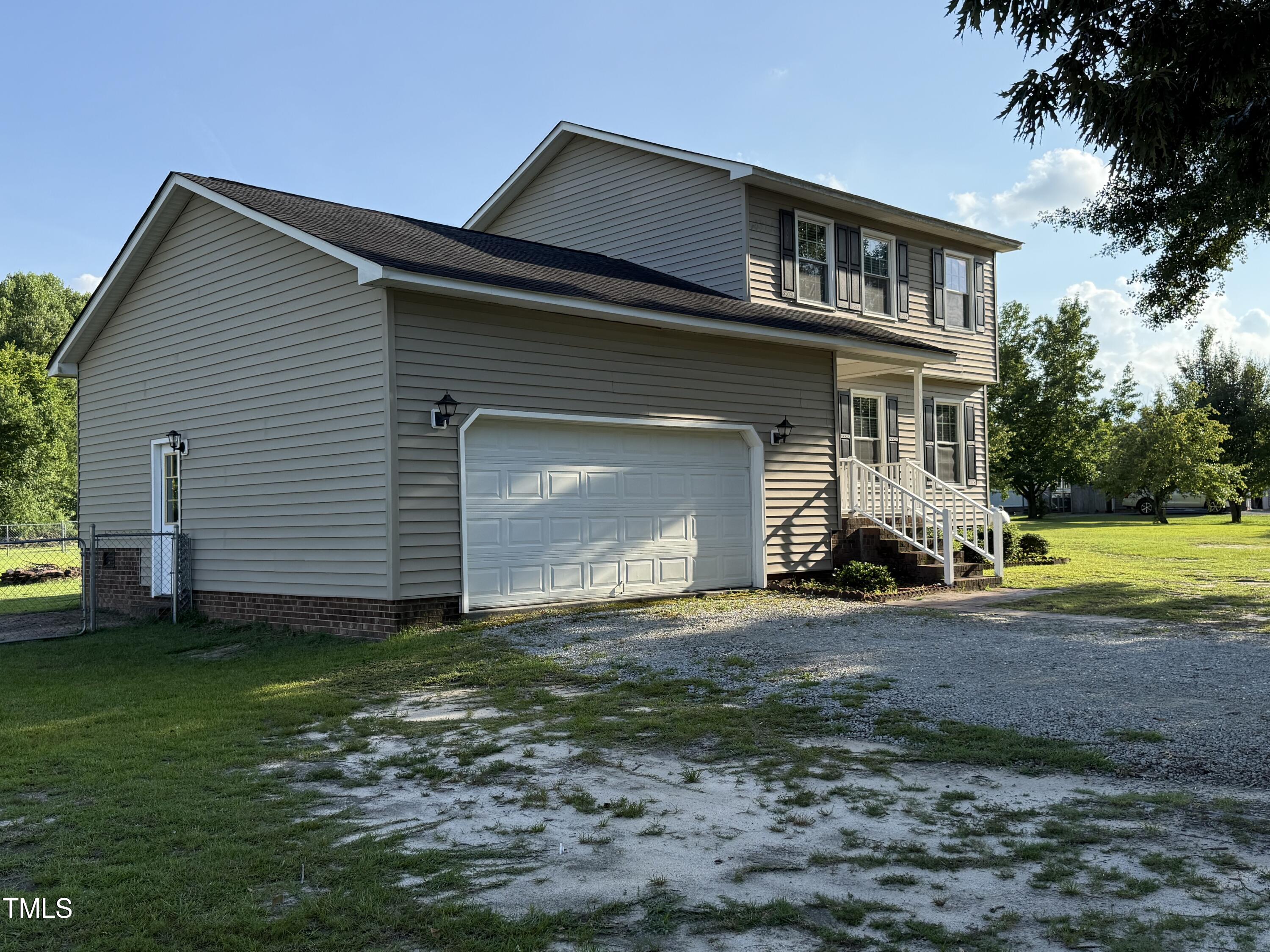 152 Christopher Avenue Princeton, NC 27569 - Photo 9 of 24 a front view of a house with a yard and garage