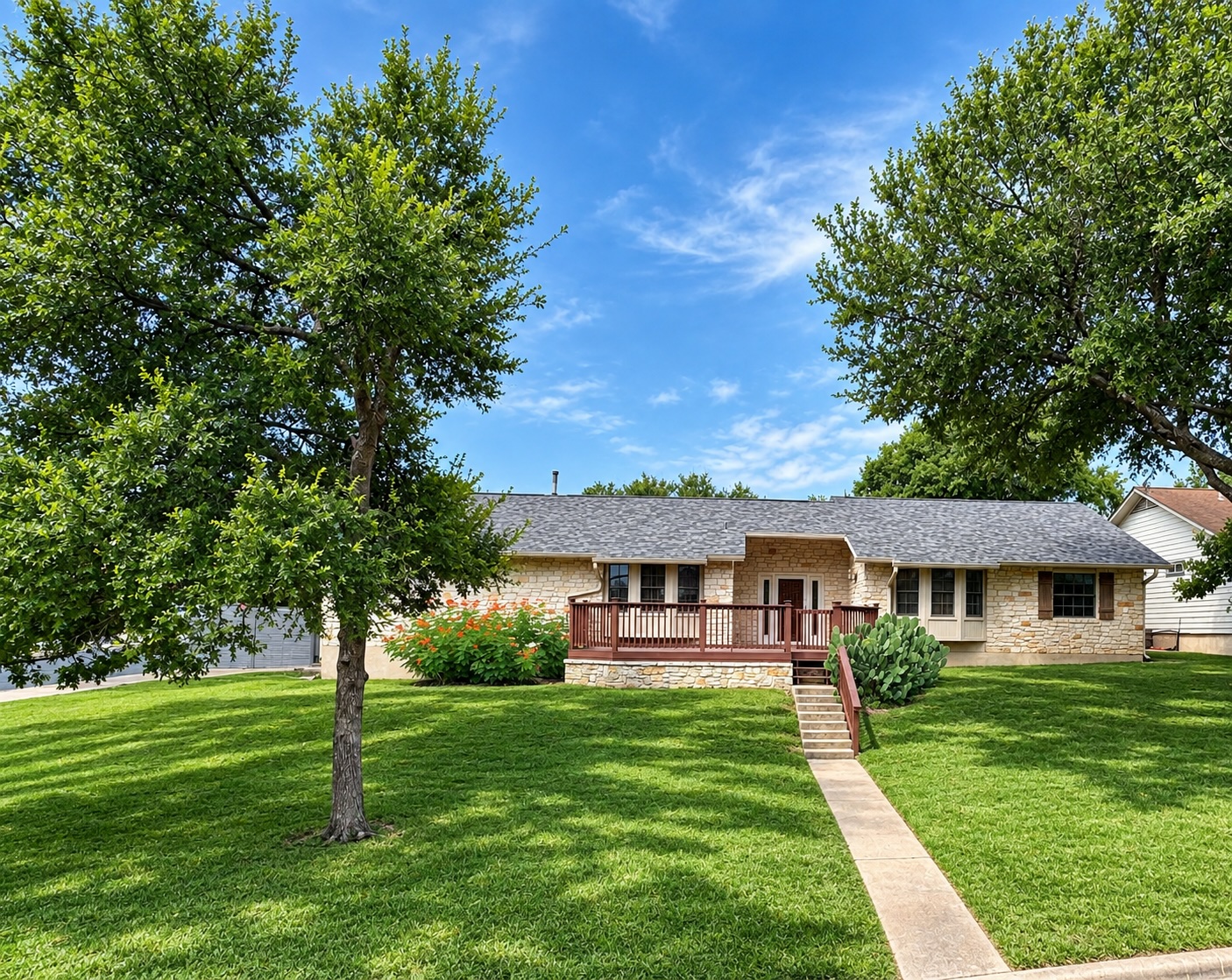 7210 Smokey Hill Road Austin, TX 78736 - Photo 1 of 29 A classic stone facade home awaits, featuring a welcoming front deck and verdant landscaping.