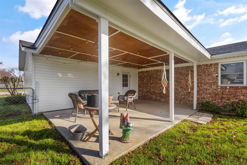708 East Prairie View Road Crowley, TX 76036 - Photo 20 of 21 Covered concrete patio featuring a wood-finish ceiling, string lighting, and white support columns