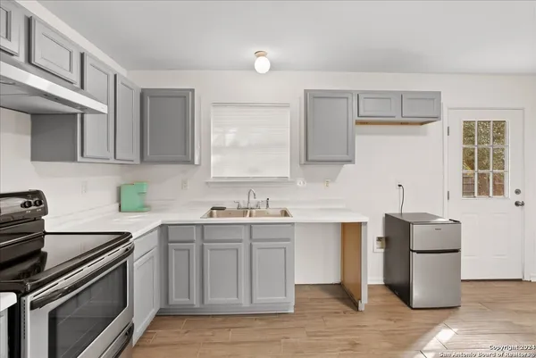 a kitchen with a sink appliances and cabinets