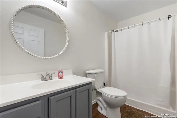 a bathroom with a sink a toilet and a mirror