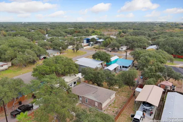 an aerial view of residential houses with outdoor space and river