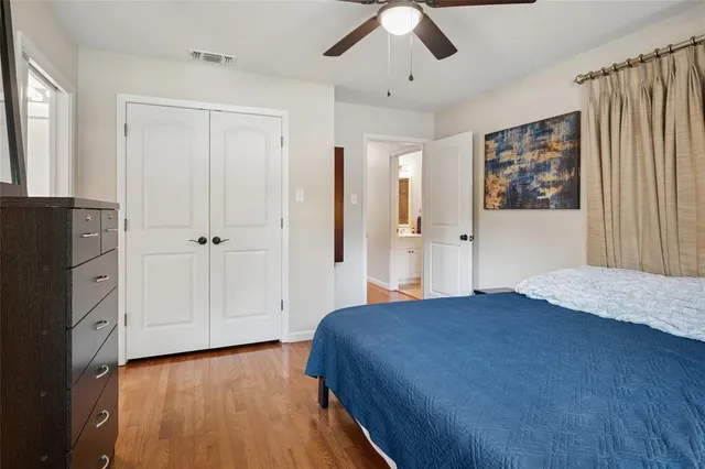 a bedroom with a large bed and a chandelier