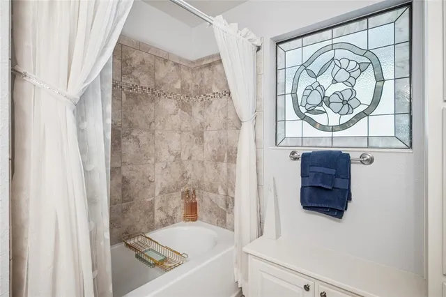 a bathroom with a bathtub and shower