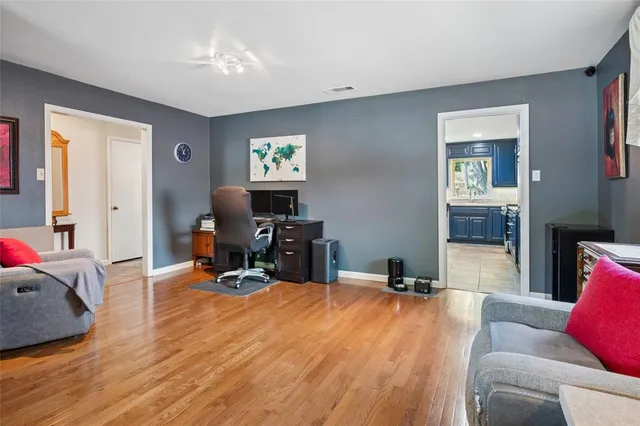 a room with table chairs and a flat screen tv