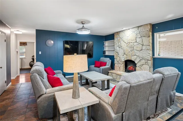 a living room with furniture fireplace and flat screen tv
