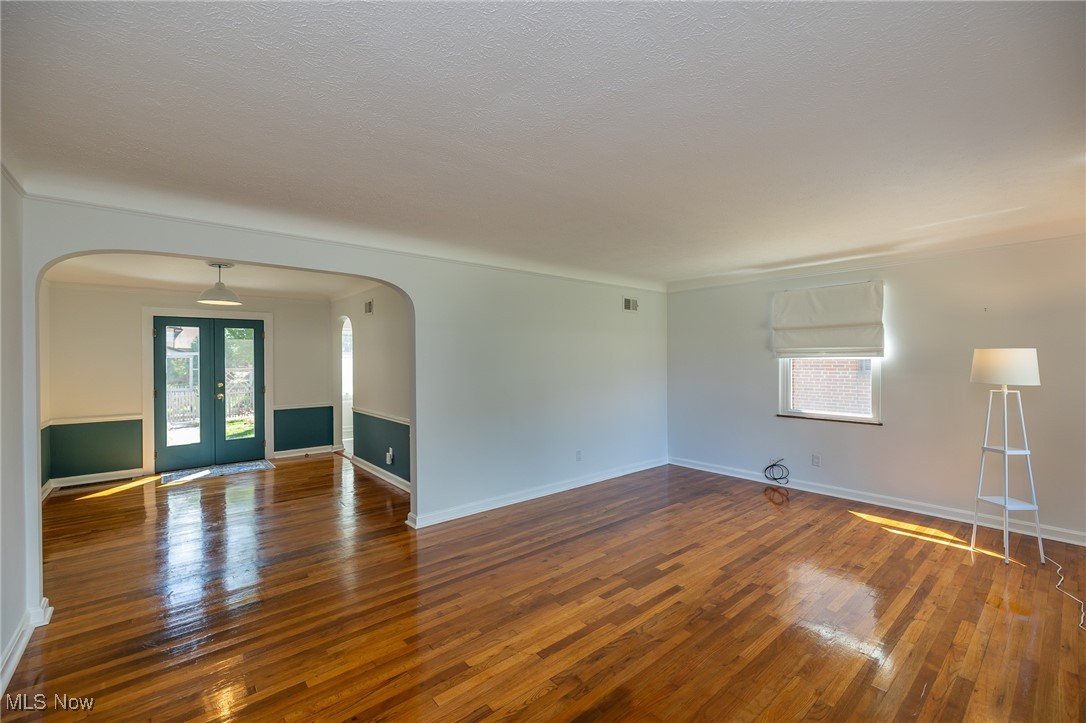 21475 Eaton Road Cleveland, OH 44126 - Photo 18 of 31 Spare room featuring dark hardwood / wood-style floors, a textured ceiling, and french doors