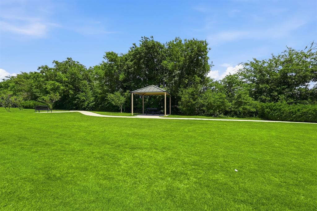 539 Farrell Lane Allen, TX 75013 - Photo 37 of 39 Expansive green space featuring a paved walkway, a freestanding gazebo with a gabled roof, and mature perimeter trees