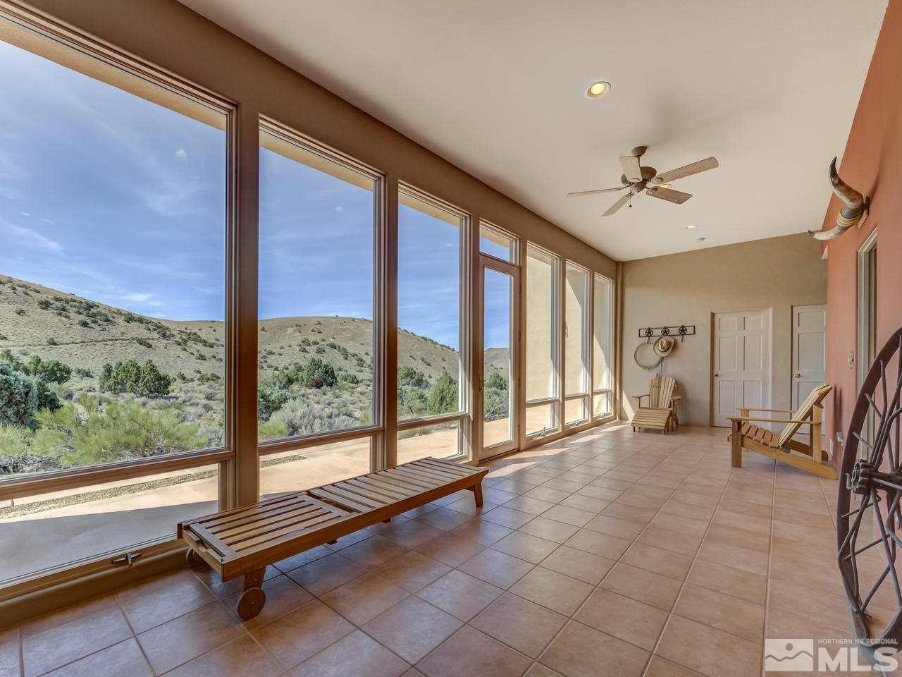 7280 Sage Canyon Road Reno, NV 89510 - Photo 3 of 23 a living room with furniture and a floor to ceiling window