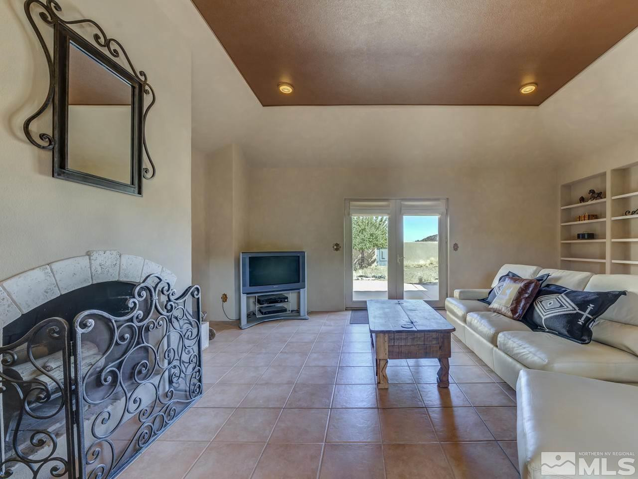 7280 Sage Canyon Road Reno, NV 89510 - Photo 9 of 23 a living room with furniture and a fireplace