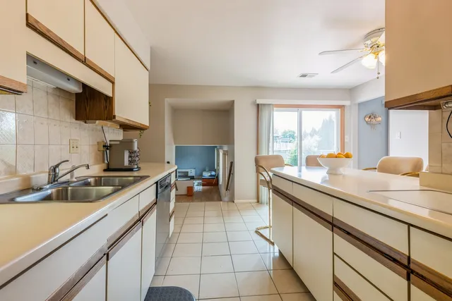 a kitchen with a sink and a stove top oven