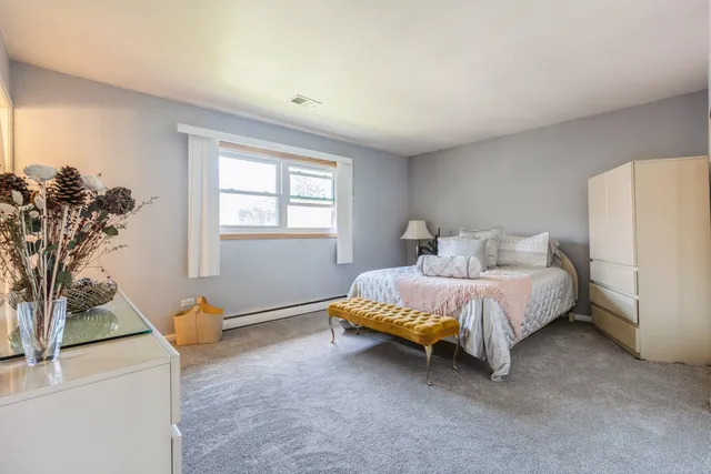 a spacious bedroom with a bed and a window