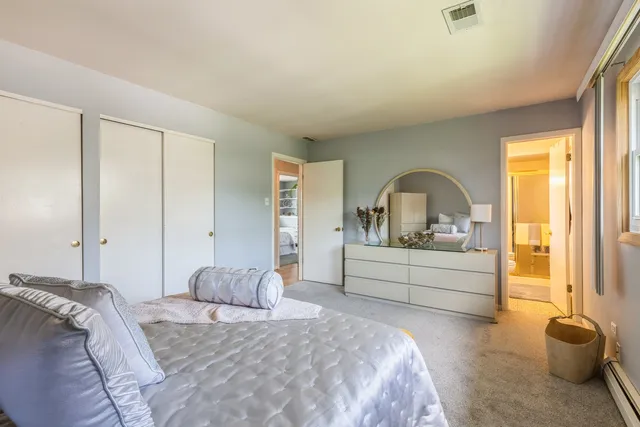 a bedroom with a bed and a large window