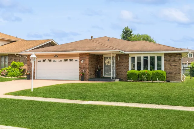 a front view of a house with a yard and garage