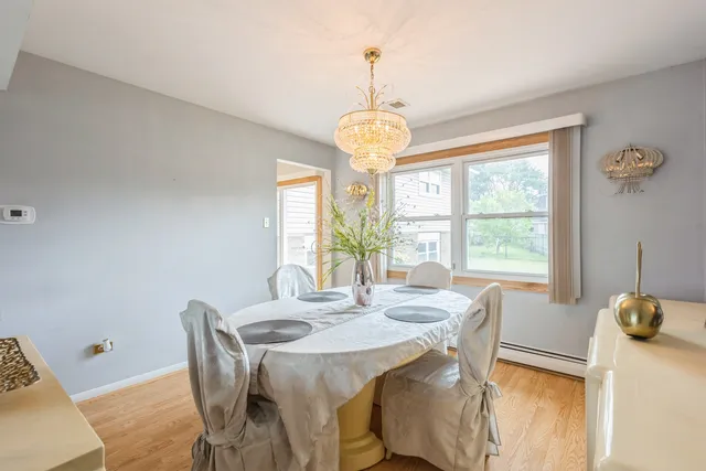 a view of a dining room with furniture wooden floor and chandelier