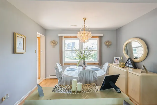 a living room with furniture a chandelier and a large window