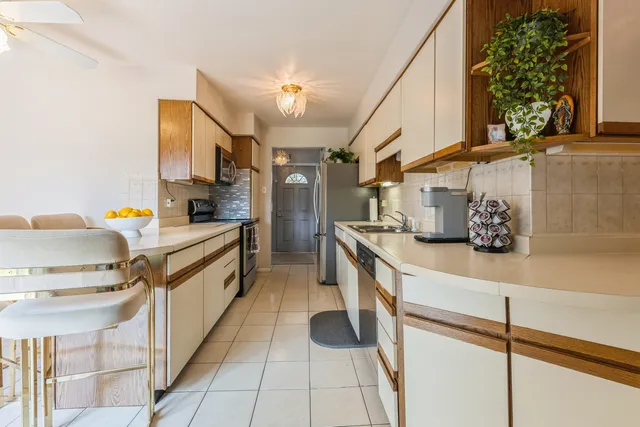 a kitchen with stainless steel appliances a sink stove and cabinets