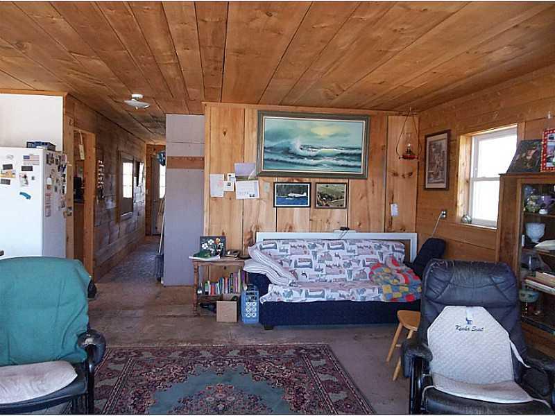 136 Embden Pond Road Anson, ME 04958 - Photo 15 of 19 Living Room. Lots of pine woodwork.