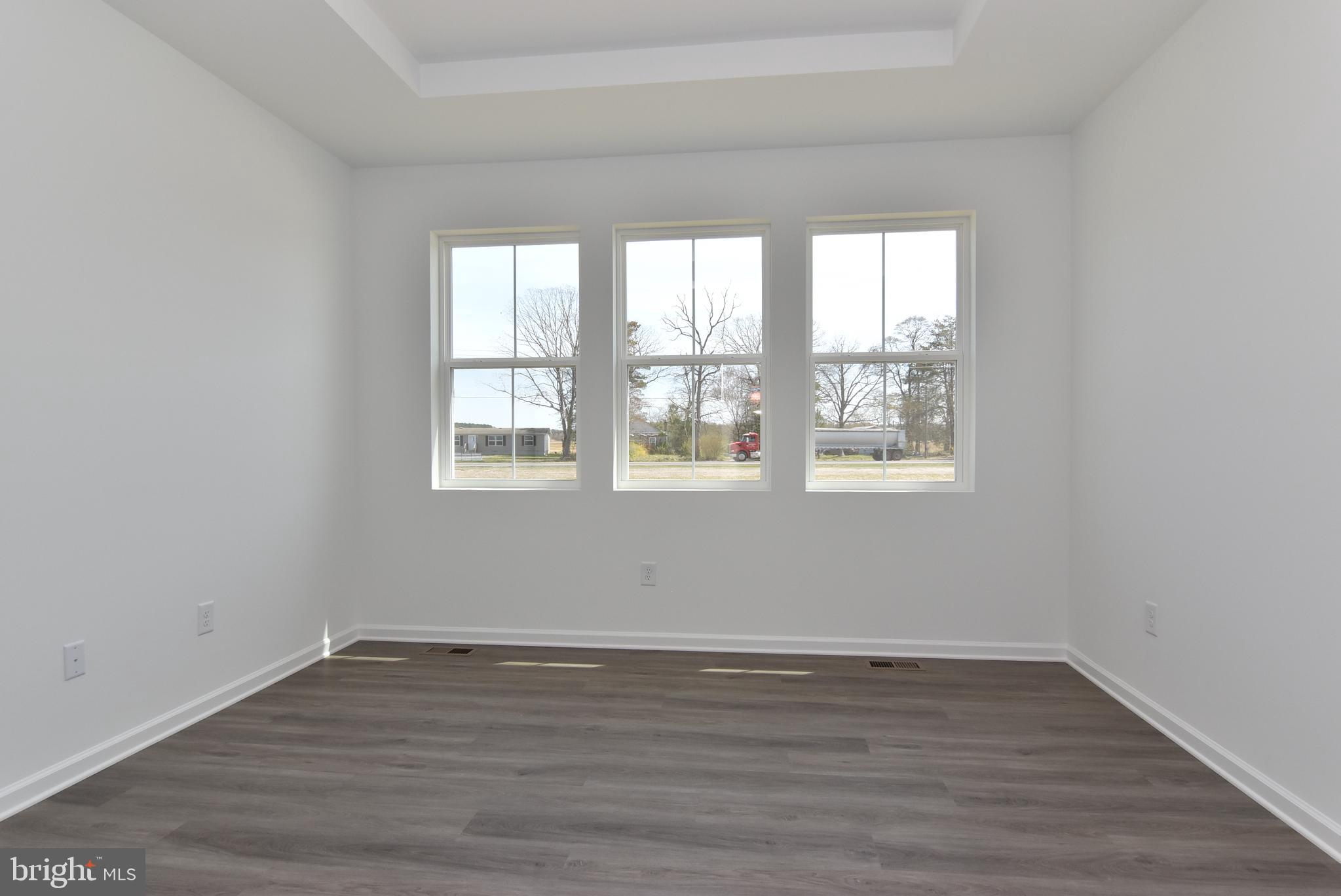36366 Gate Drive Georgetown, DE 19947 - Photo 14 of 23 a view of an empty room with wooden floor and a window