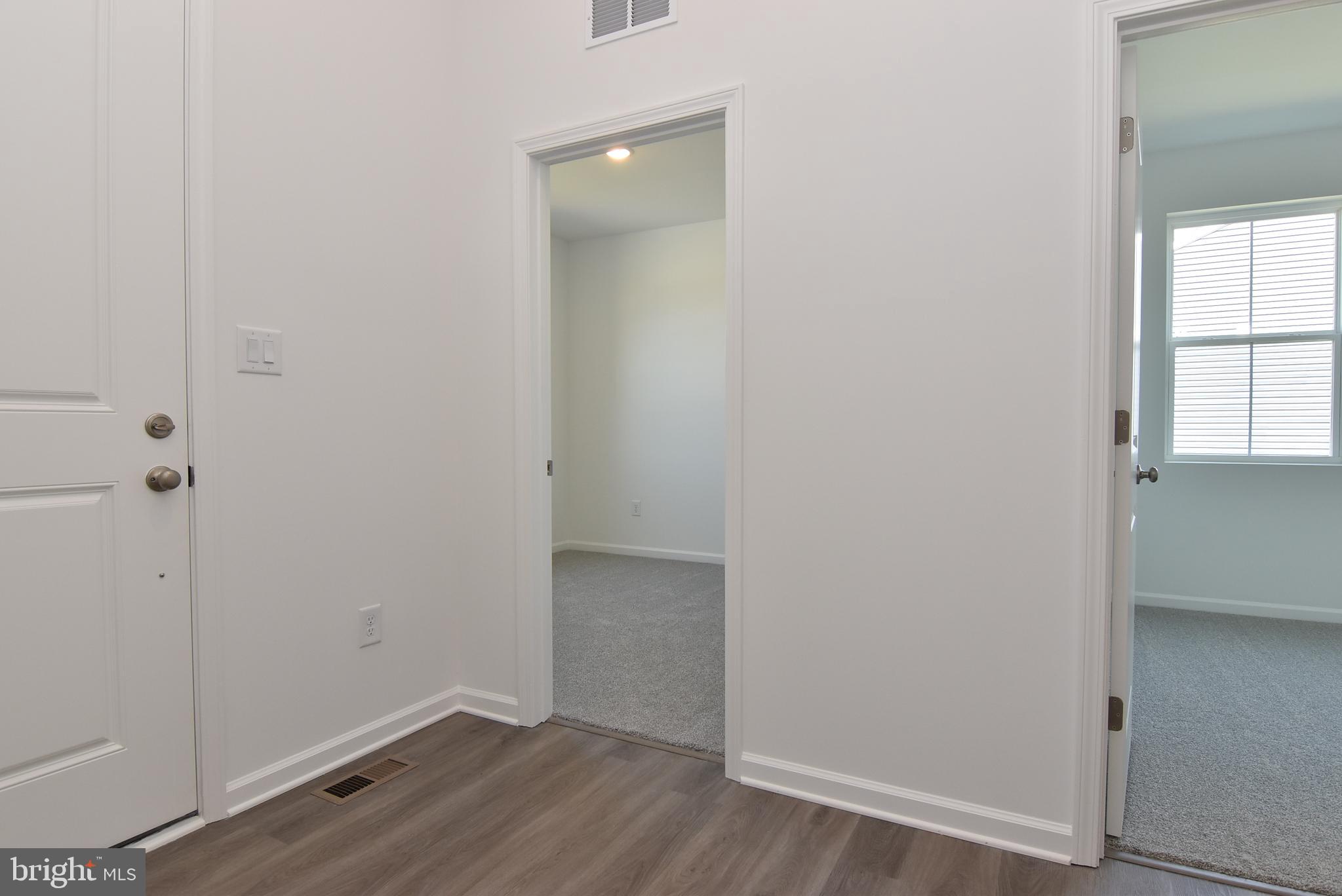 36366 Gate Drive Georgetown, DE 19947 - Photo 18 of 23 an empty room with wooden floor and windows