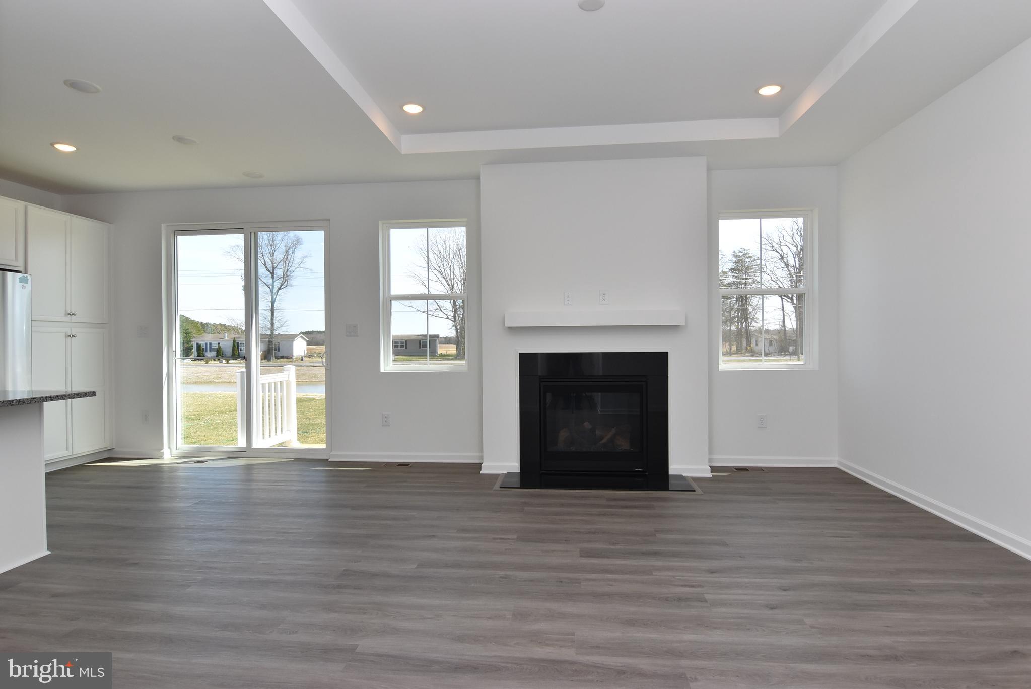 36366 Gate Drive Georgetown, DE 19947 - Photo 2 of 23 a view of an empty room with wooden floor and a window