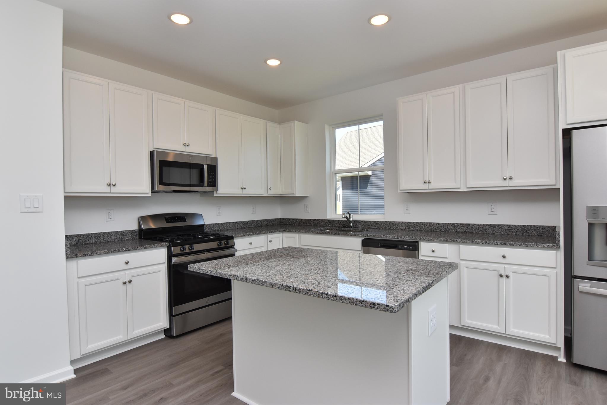 36366 Gate Drive Georgetown, DE 19947 - Photo 6 of 23 a kitchen with granite countertop white cabinets and stainless steel appliances