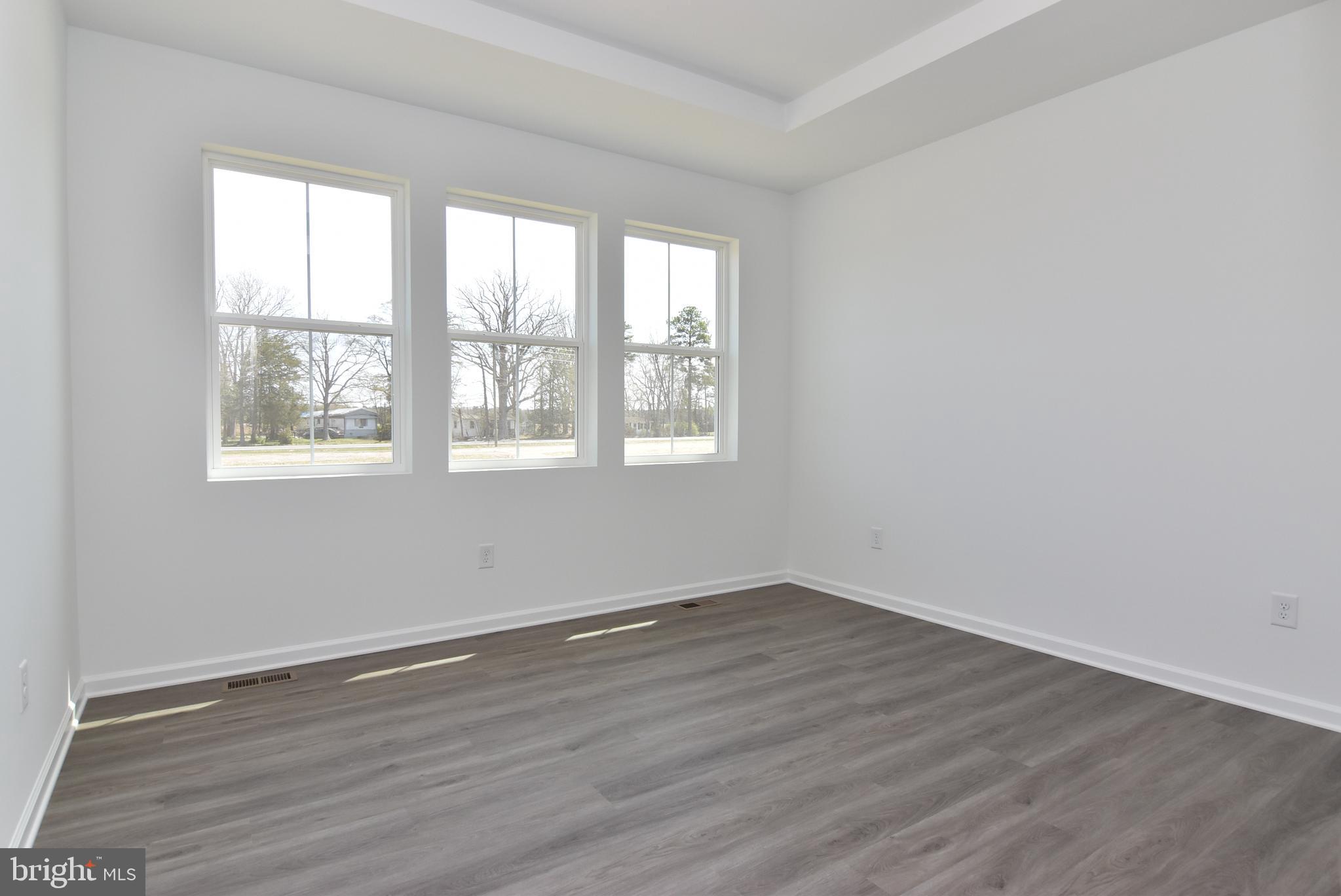 36366 Gate Drive Georgetown, DE 19947 - Photo 9 of 23 a view of an empty room with wooden floor and a window