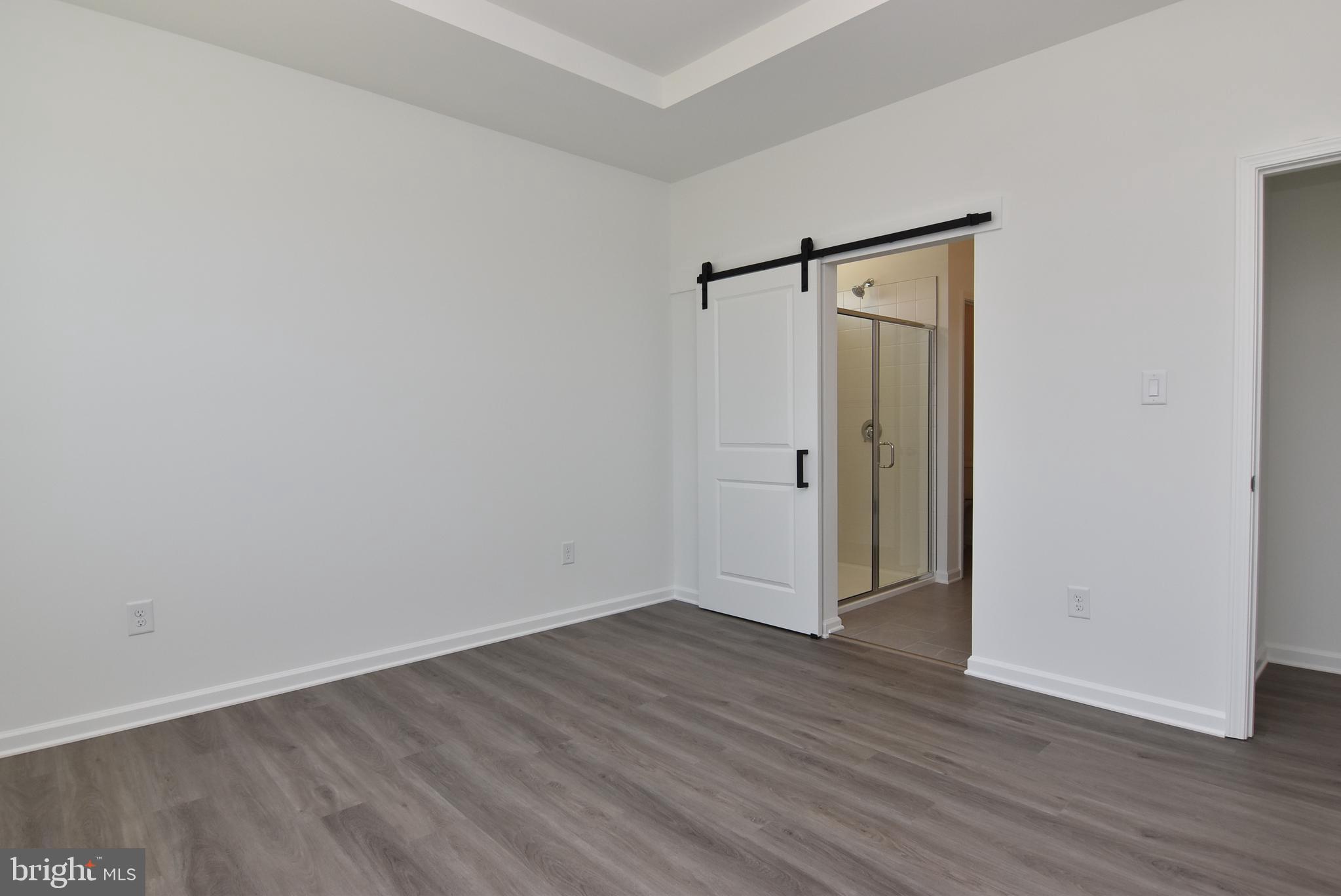 36366 Gate Drive Georgetown, DE 19947 - Photo 10 of 23 an empty room with wooden floor and a window
