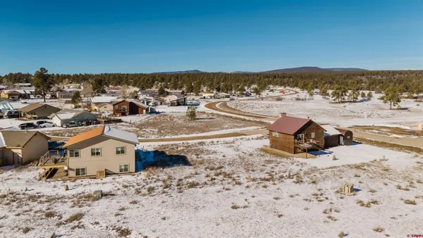 an aerial view of a house with a ocean beach