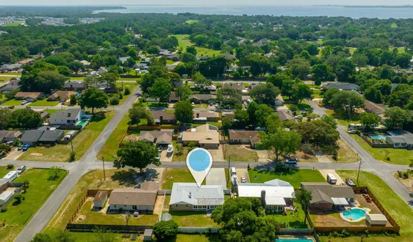 an aerial view of residential houses with outdoor space