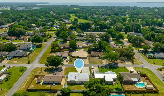 an aerial view of residential houses with outdoor space