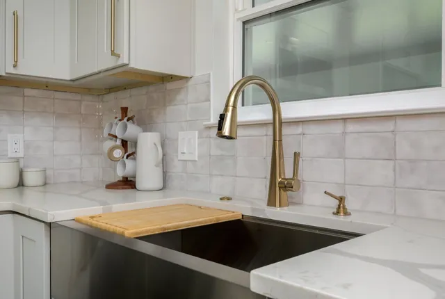 a kitchen with a sink and granite