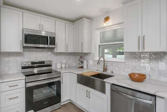 a kitchen with a sink stove and microwave