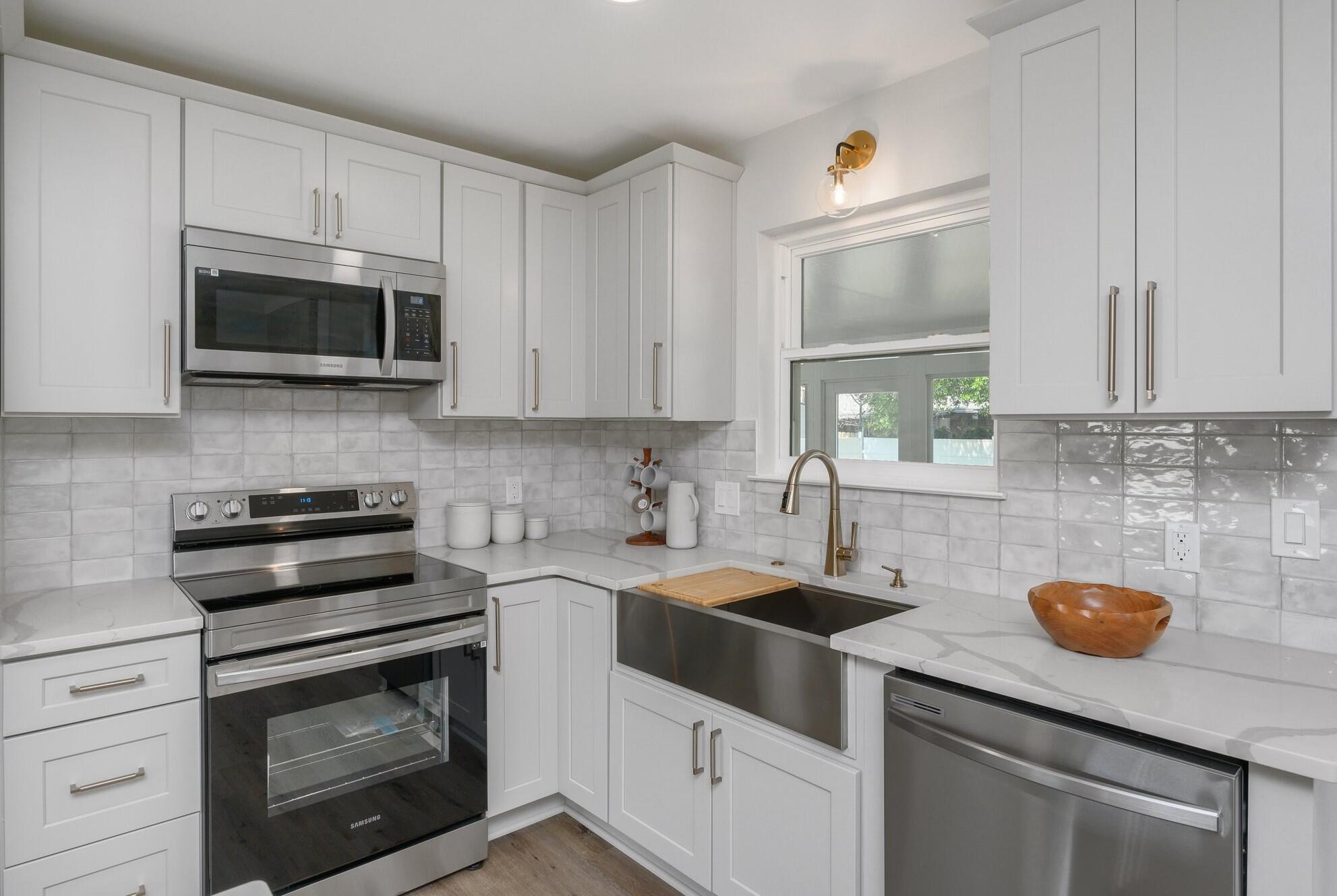 79 11th Street Shalimar, FL 32579 - Photo 12 of 36 a kitchen with a sink stove and microwave