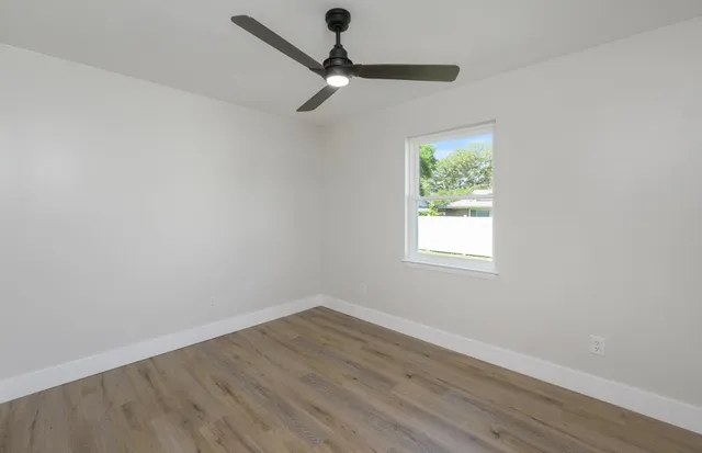 a view of a room with wooden floor