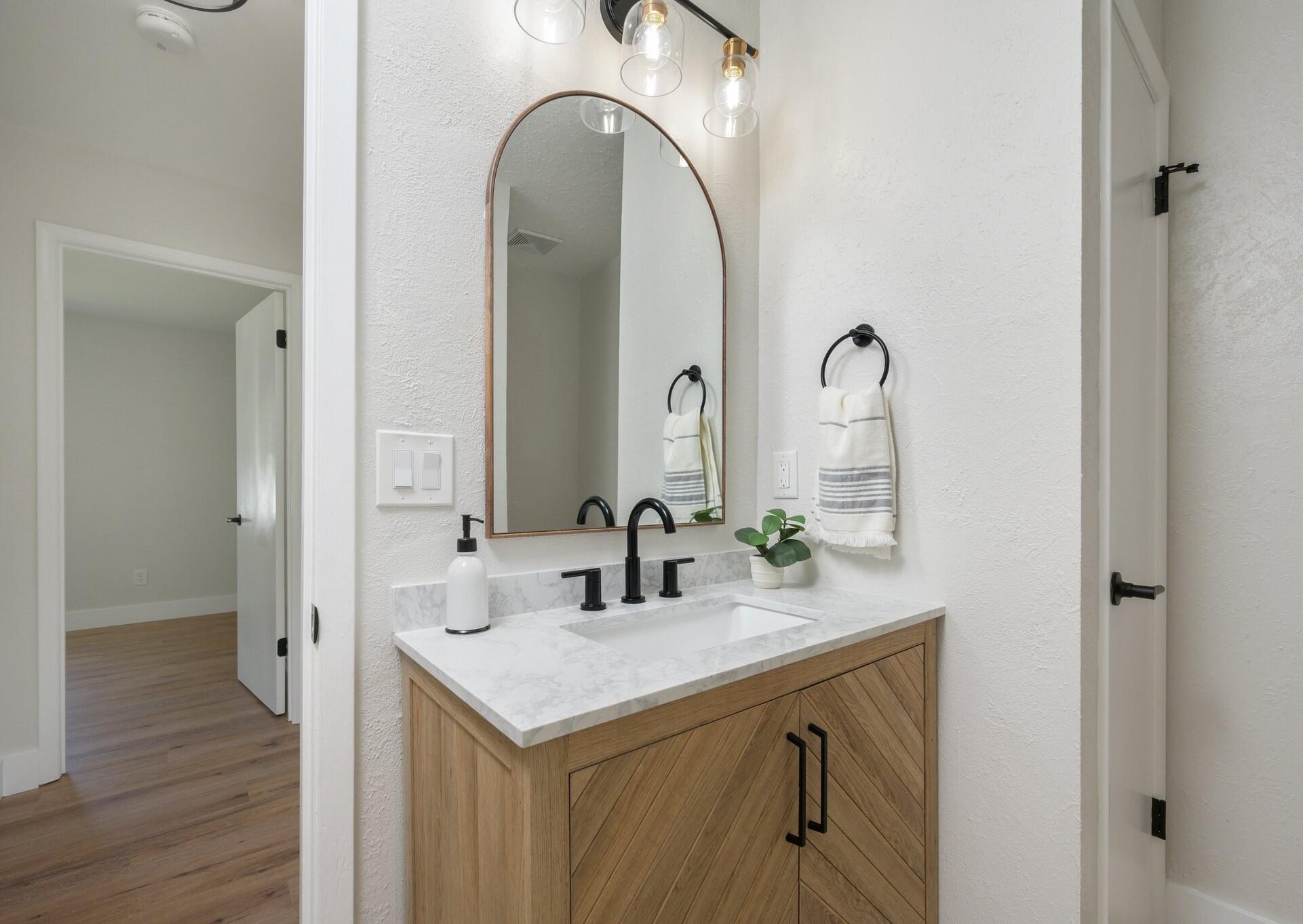 79 11th Street Shalimar, FL 32579 - Photo 23 of 36 a bathroom with a double vanity sink and a mirror