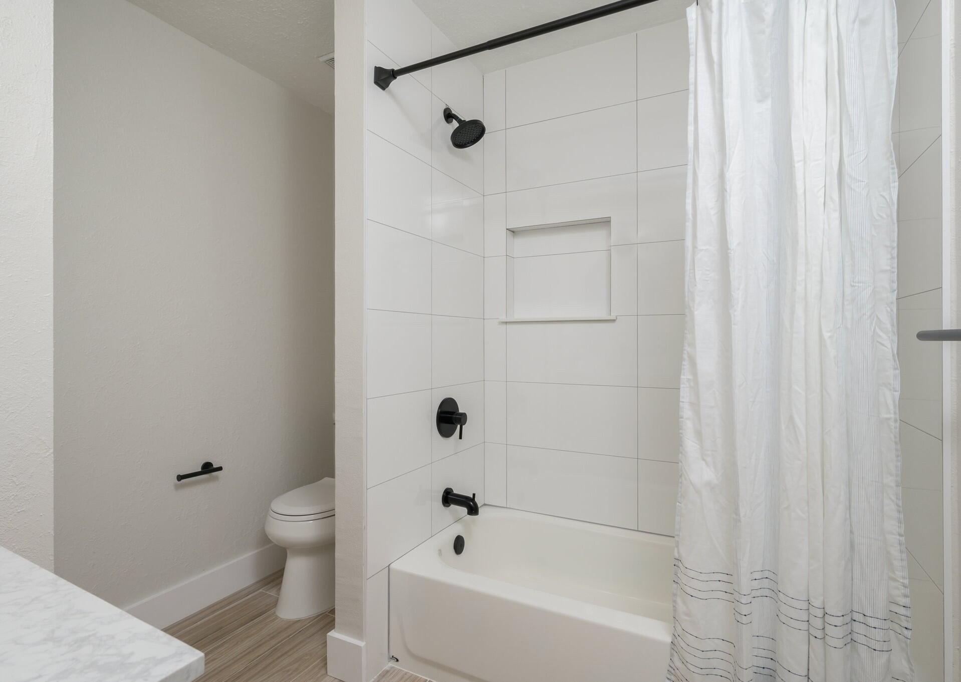 79 11th Street Shalimar, FL 32579 - Photo 25 of 36 a bathroom with a bathtub and shower