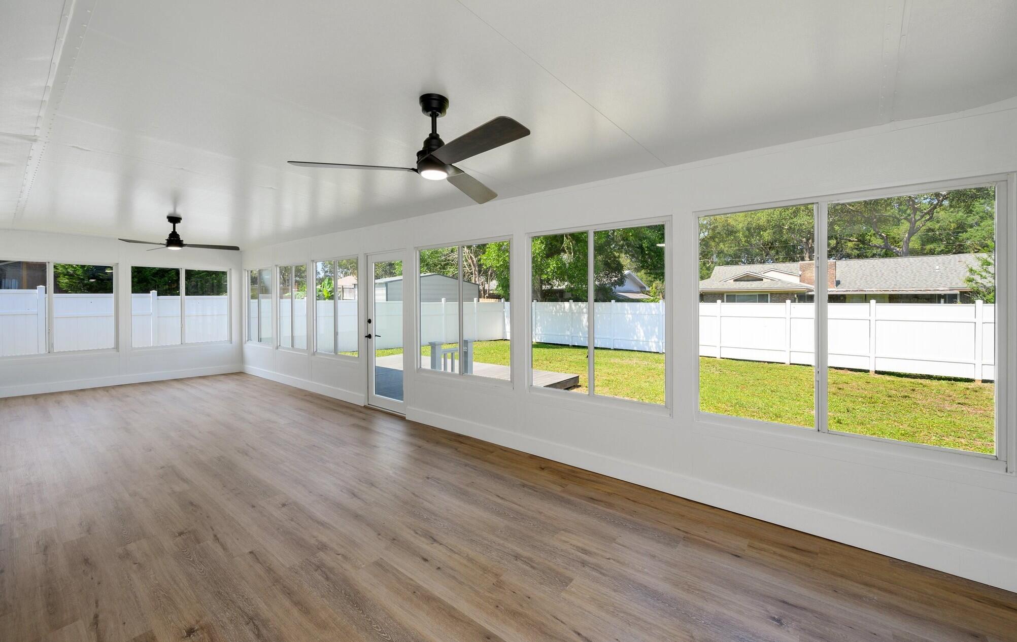 79 11th Street Shalimar, FL 32579 - Photo 28 of 36 a view of an empty room with wooden floor and a window