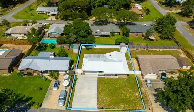 an aerial view of residential houses with outdoor space