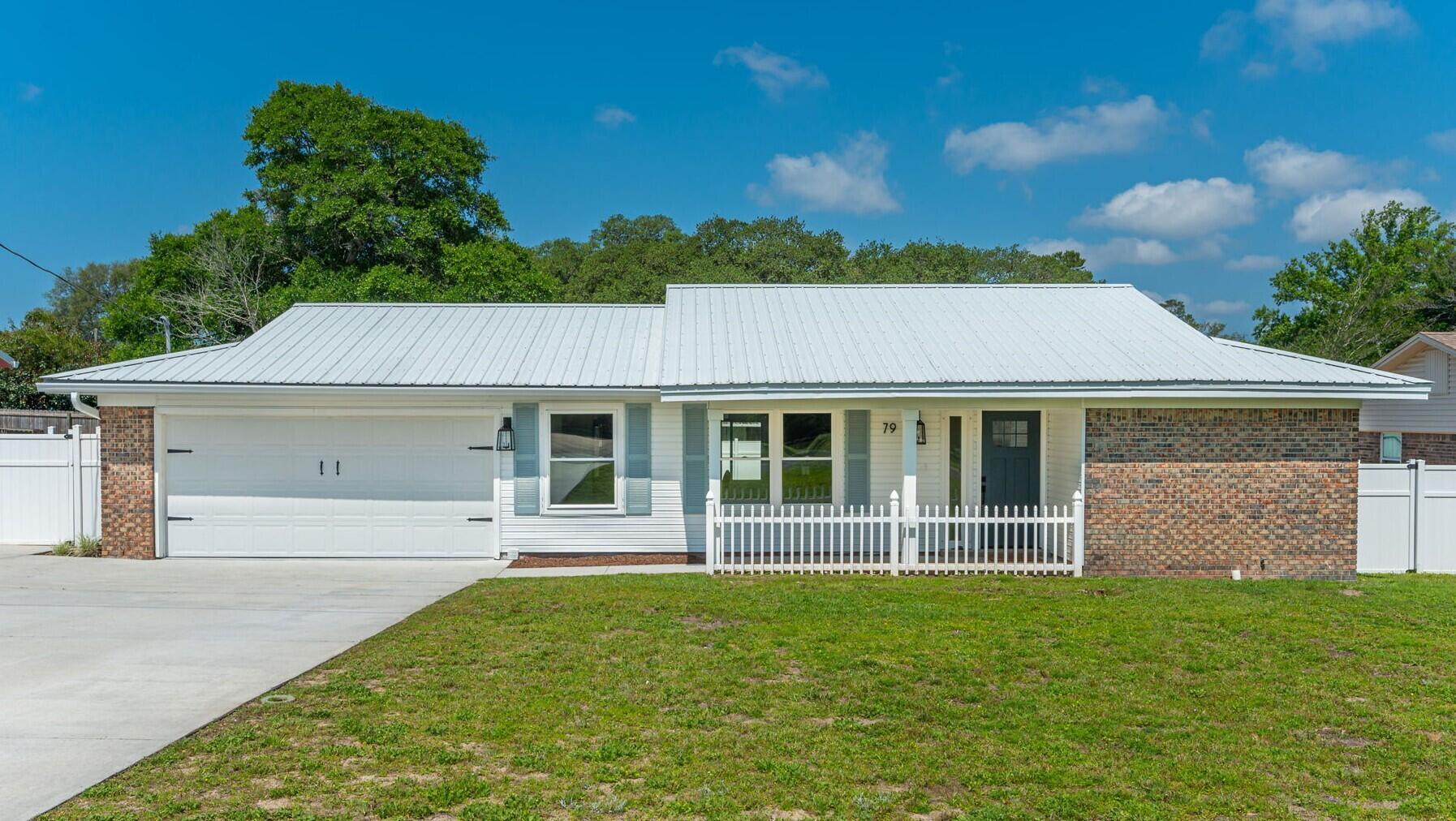 79 11th Street Shalimar, FL 32579 - Photo 4 of 36 front view of a house with a yard