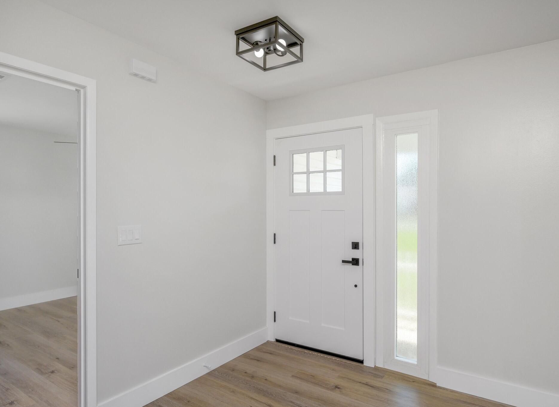 79 11th Street Shalimar, FL 32579 - Photo 5 of 36 a view of an entryway with wooden floor
