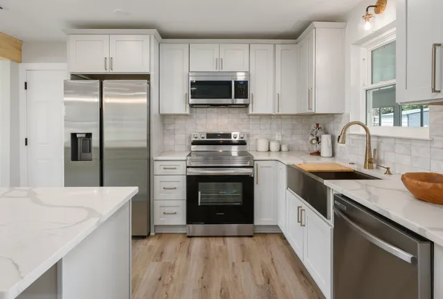 a kitchen with a sink stove and refrigerator