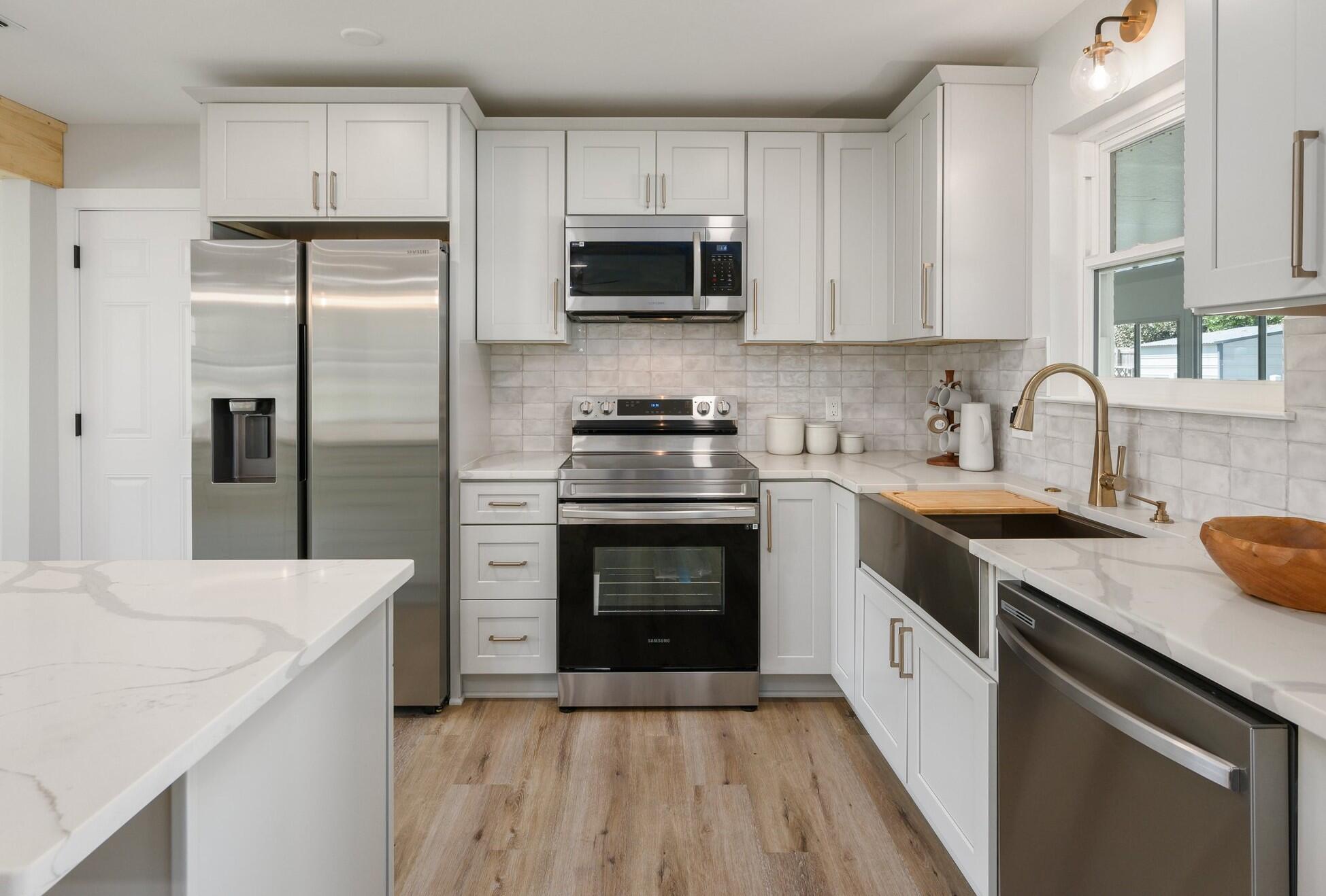79 11th Street Shalimar, FL 32579 - Photo 9 of 36 a kitchen with a sink stove and refrigerator